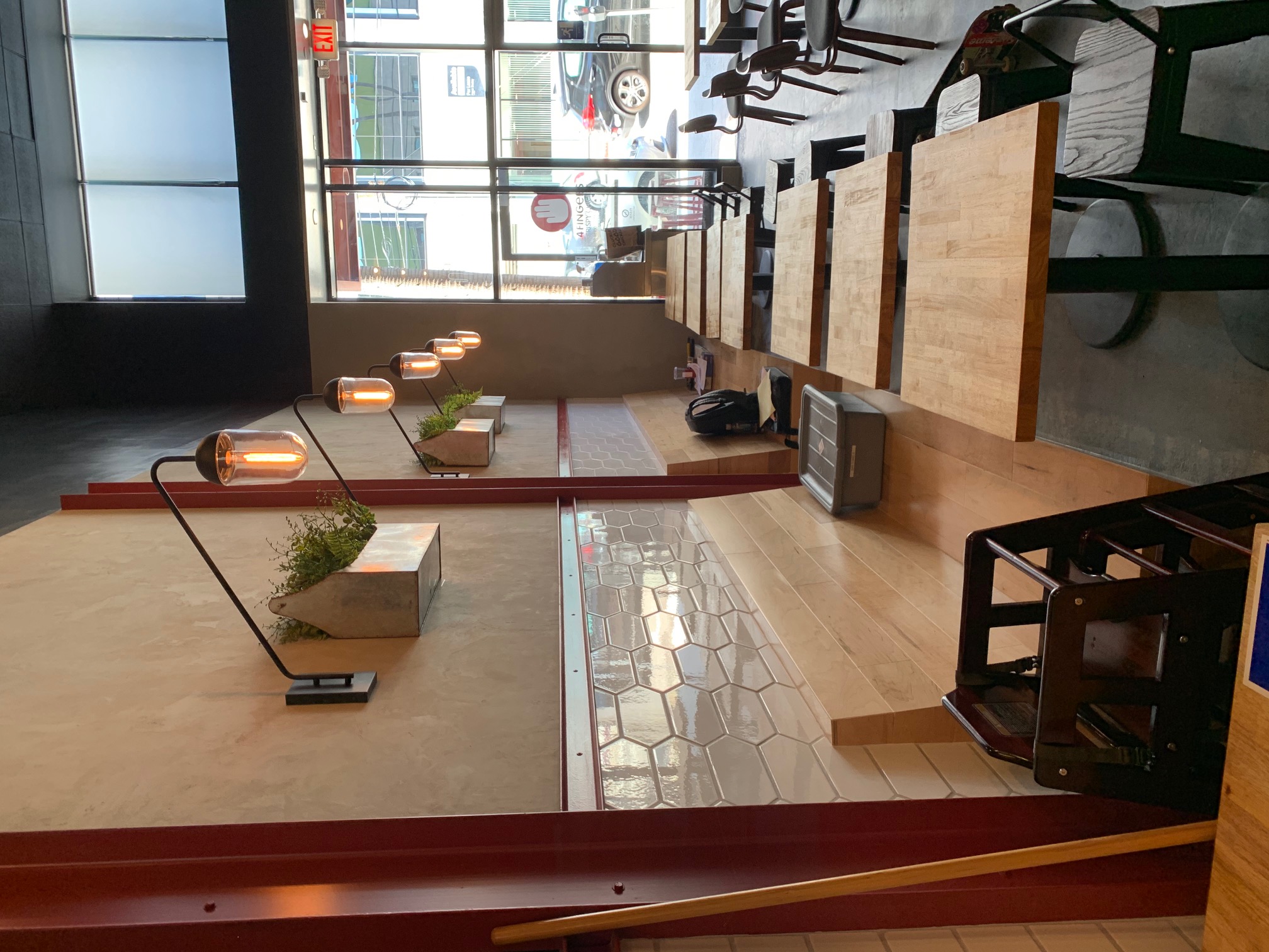 Order counter with menu screens, hexagon tile, and living vine wall