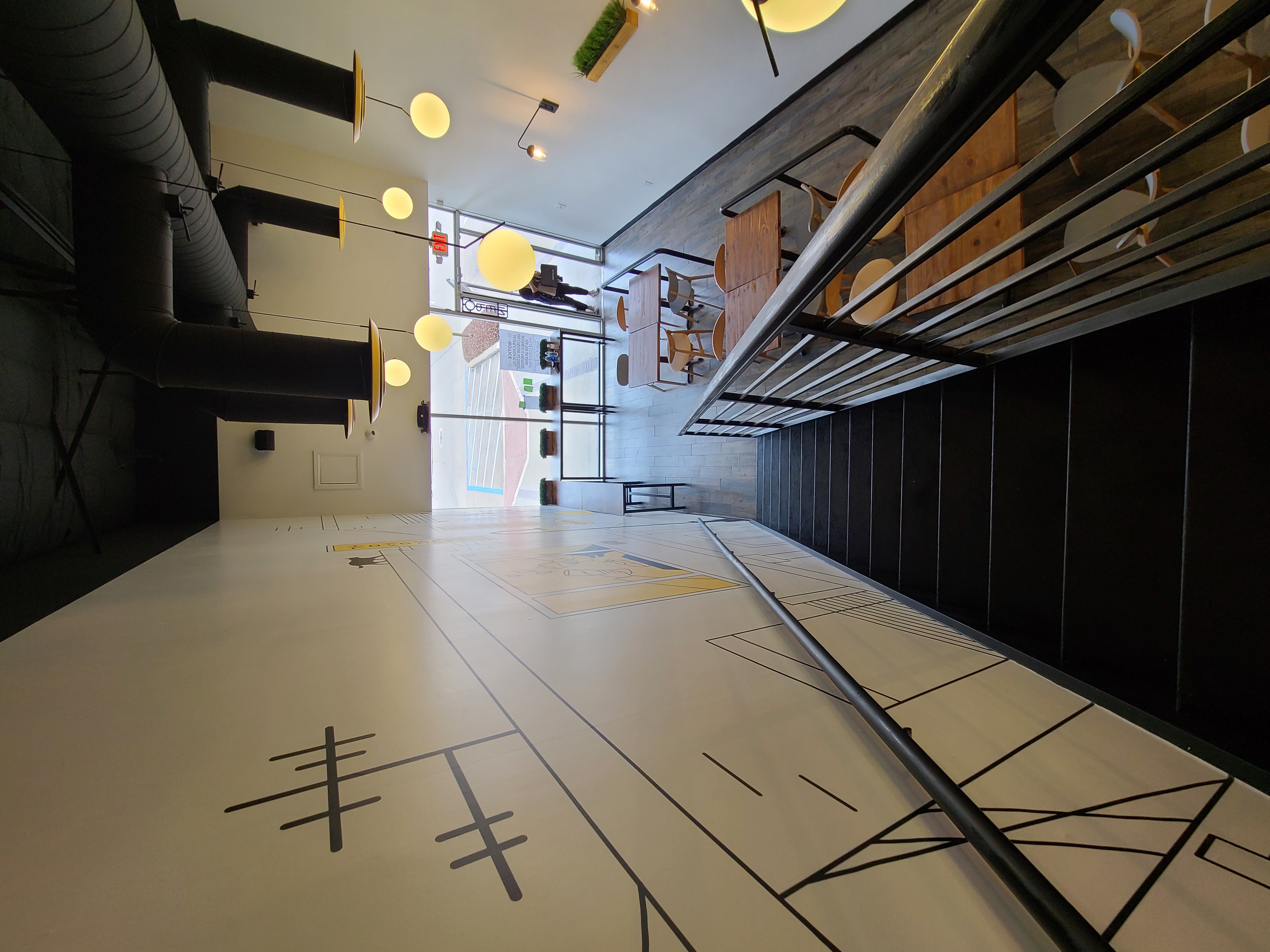 Upstairs mezzanine dining area with bridge mural