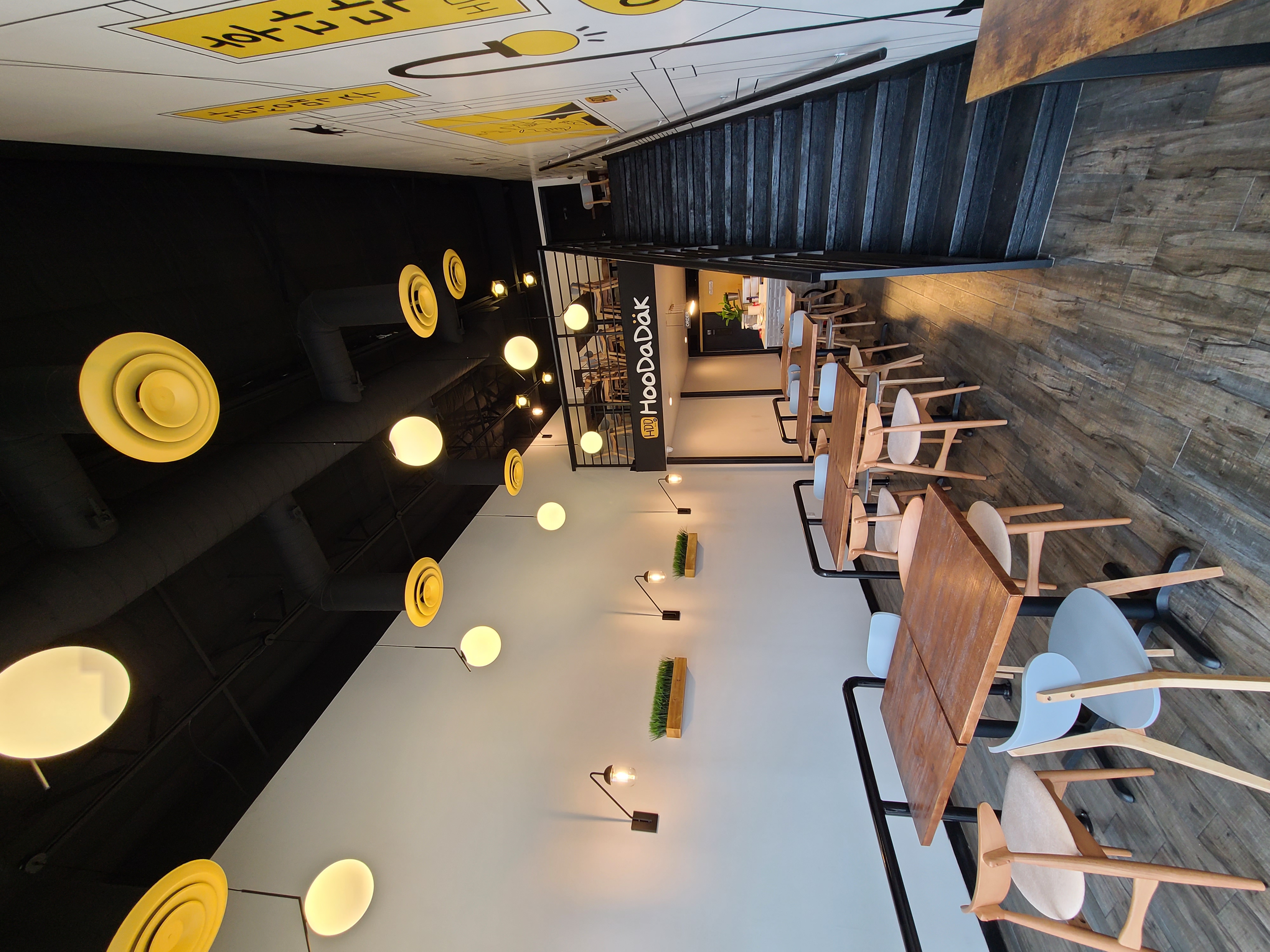 Restaurant dining room with pendant lighting and custom wall mural